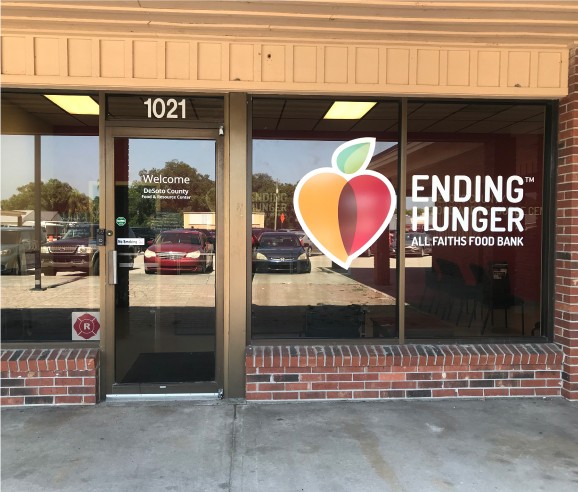 A window of an eating place with the words " ending hunger ".